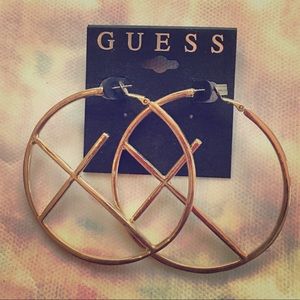 Guess gold hoop cross earrings.